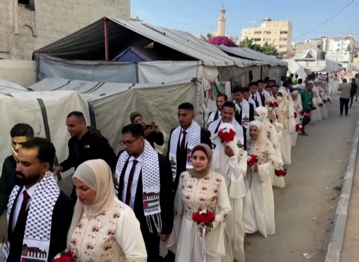 Mass wedding brings brief joy to couples in devastated Gaza